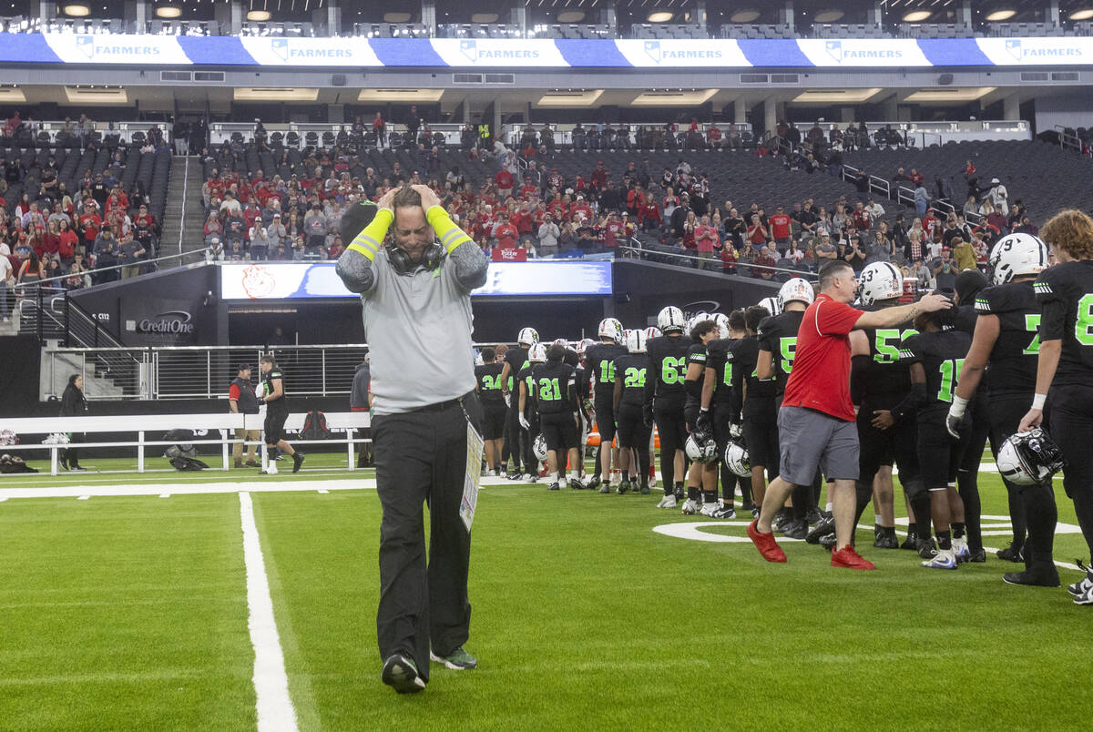 SLAM Academy Head Coach Mike Cofer places his hands on his head after winning the Class 3A foot ...