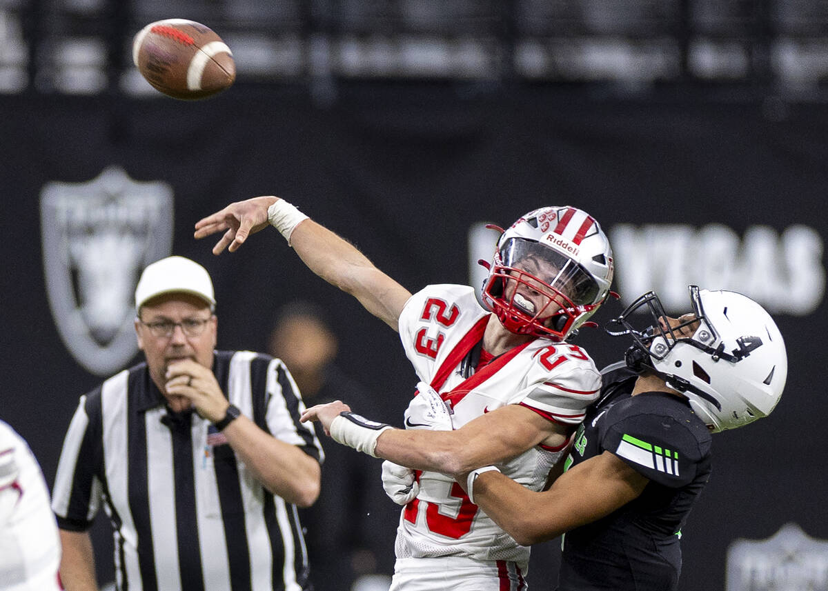 Truckee senior Jace Estabrook (23) throws the ball away while being tackled by SLAM Academy jun ...