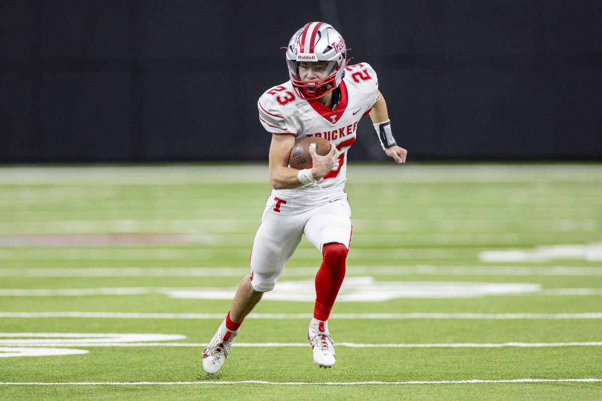 Truckee senior Jace Estabrook (23) runs with the ball during the Class 3A football state champi ...