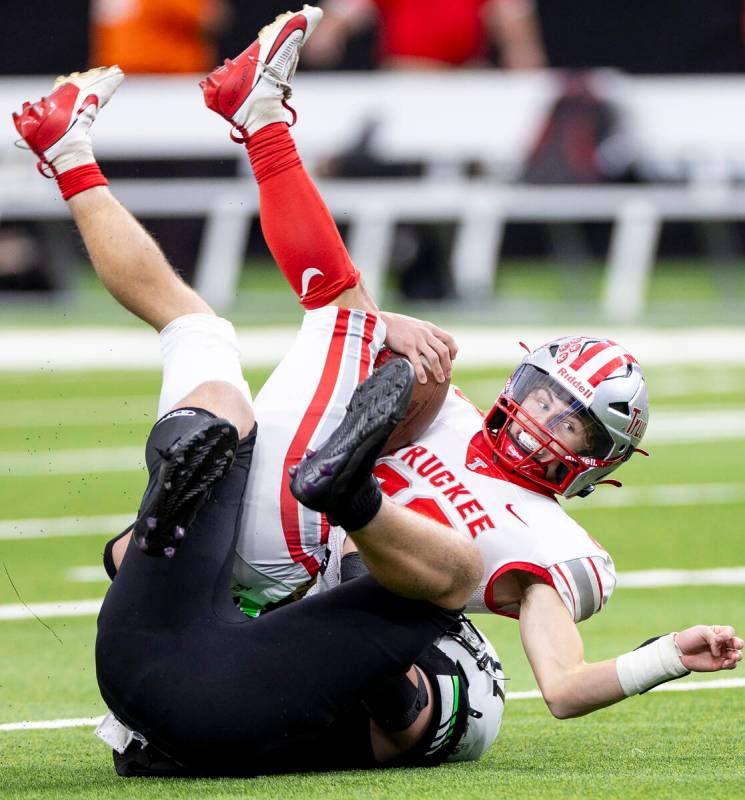 Truckee senior Jace Estabrook, top, is tackled by SLAM Academy senior Dylan Tondreau, bottom, d ...