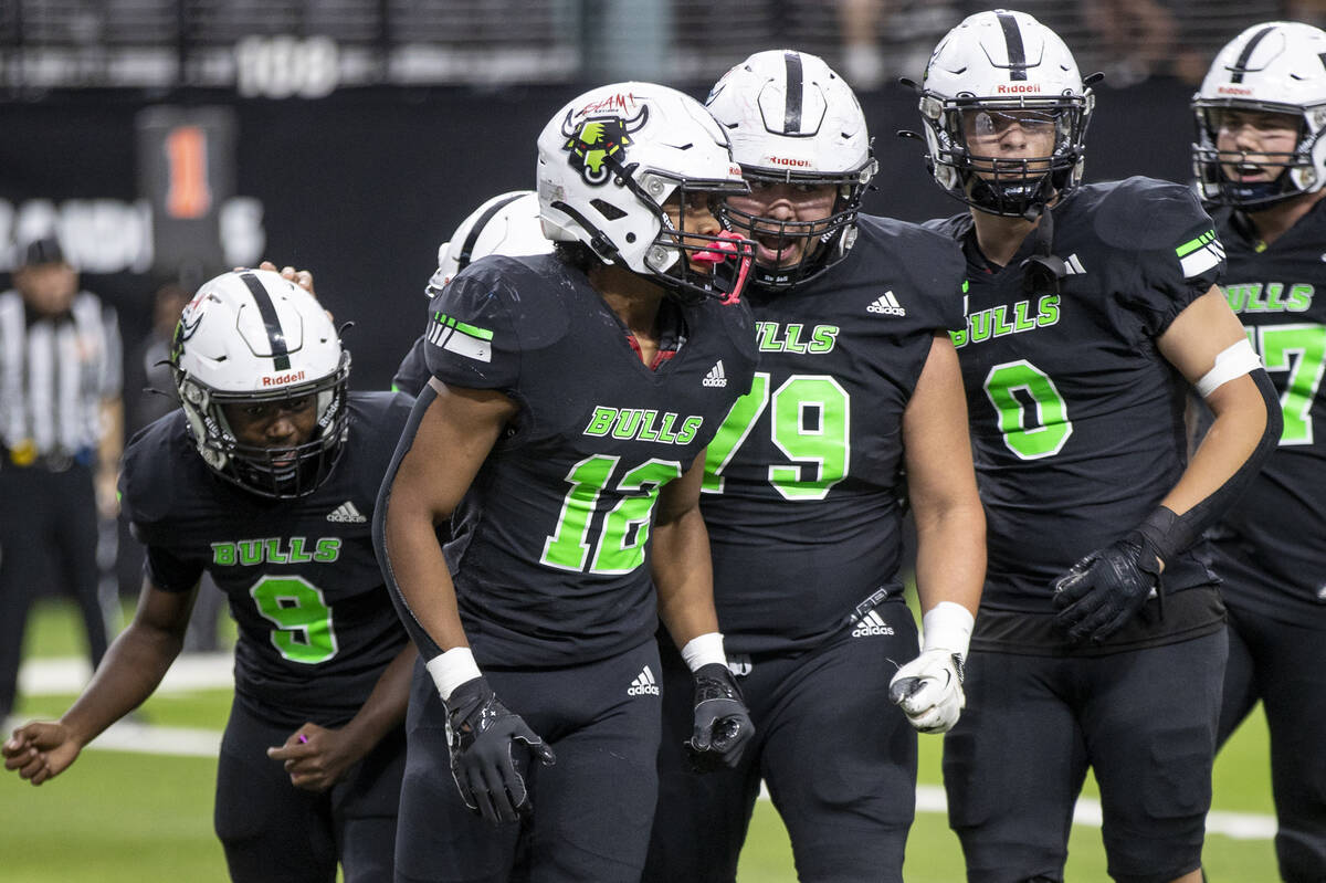 SLAM Academy senior Damien Nevil (12) celebrates with his teammates after scoring a touchdown d ...