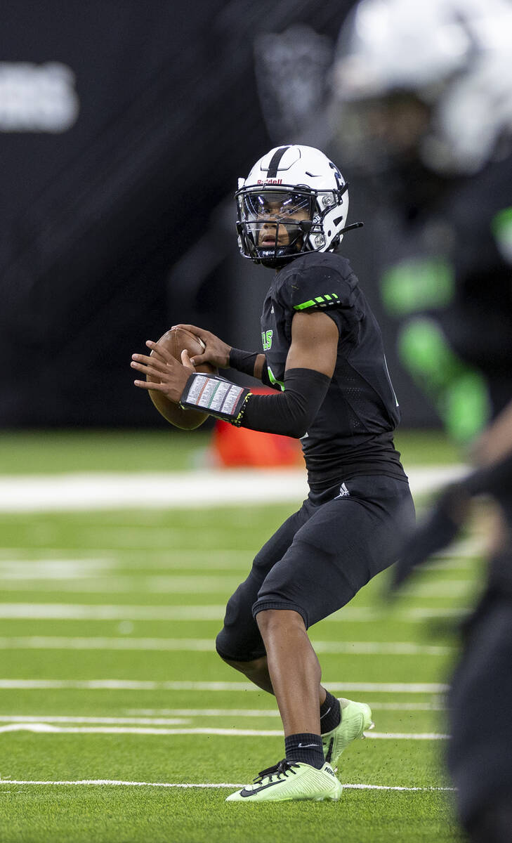 SLAM Academy junior Alaijah Young (2) looks to throw the ball during the Class 3A football stat ...