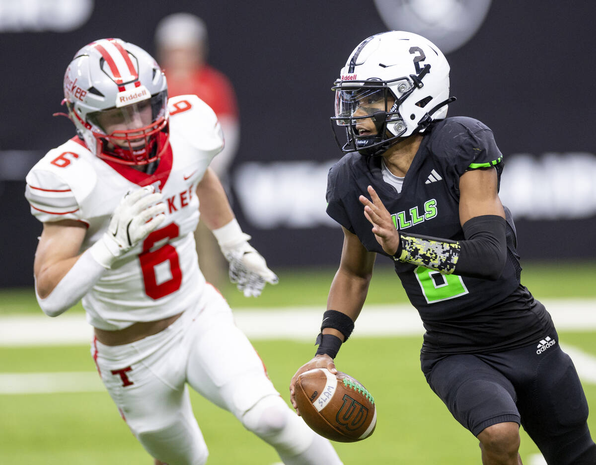 SLAM Academy junior Alaijah Young (2) looks to throw the ball during the Class 3A football stat ...