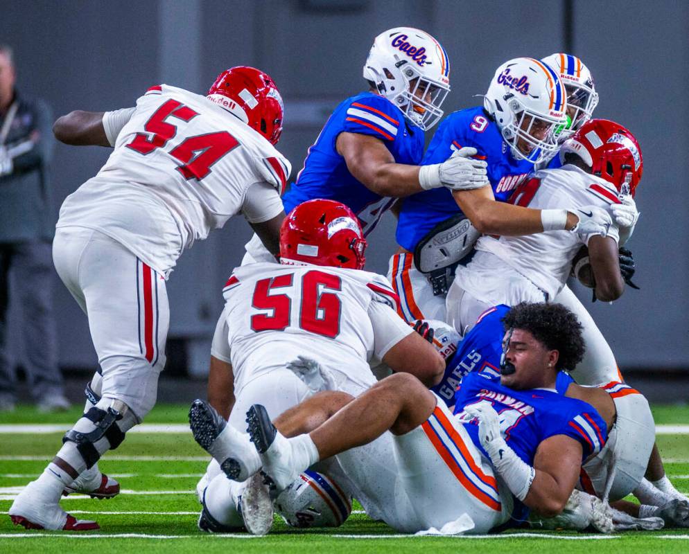 Arbor View running back Kamareion Bell (0) is stopped by Bishop Gorman linebacker Aloisio Malui ...