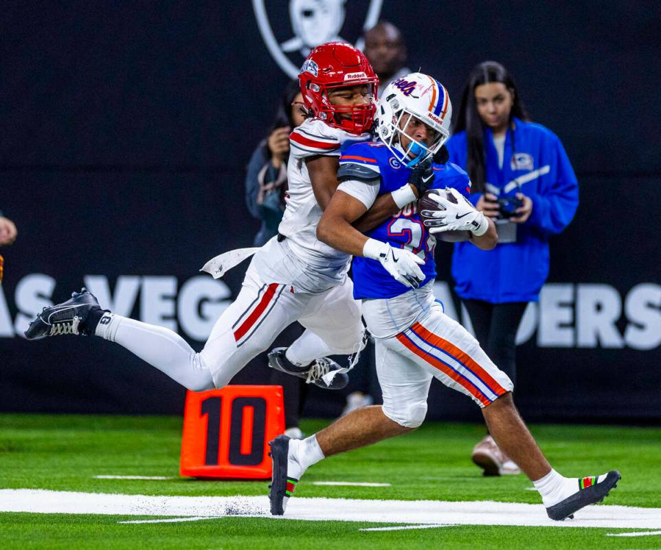 Bishop Gorman running back Myles Norman (24) drags Arbor View safety Tico Pringle (4) towards ...