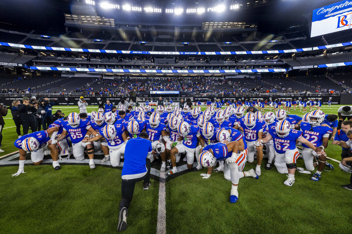 Bishop Gorman head coach Brent Browner prays with his after their 69-7 win over Arbor View for ...