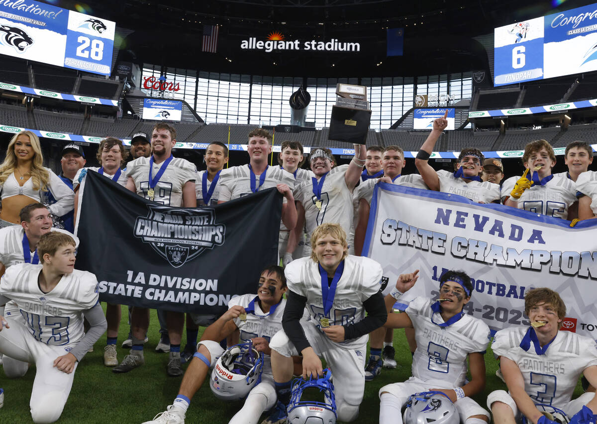 Pahranagat Valley players celebrate as they pose for a photo after topping Tonopah 28-6 to win ...