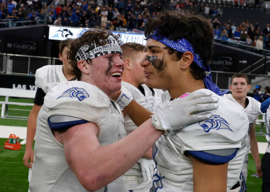 Pahranagat Valley running back A.J. Thornton (7) and defensive back Bronson Fiatoa (8) get emot ...