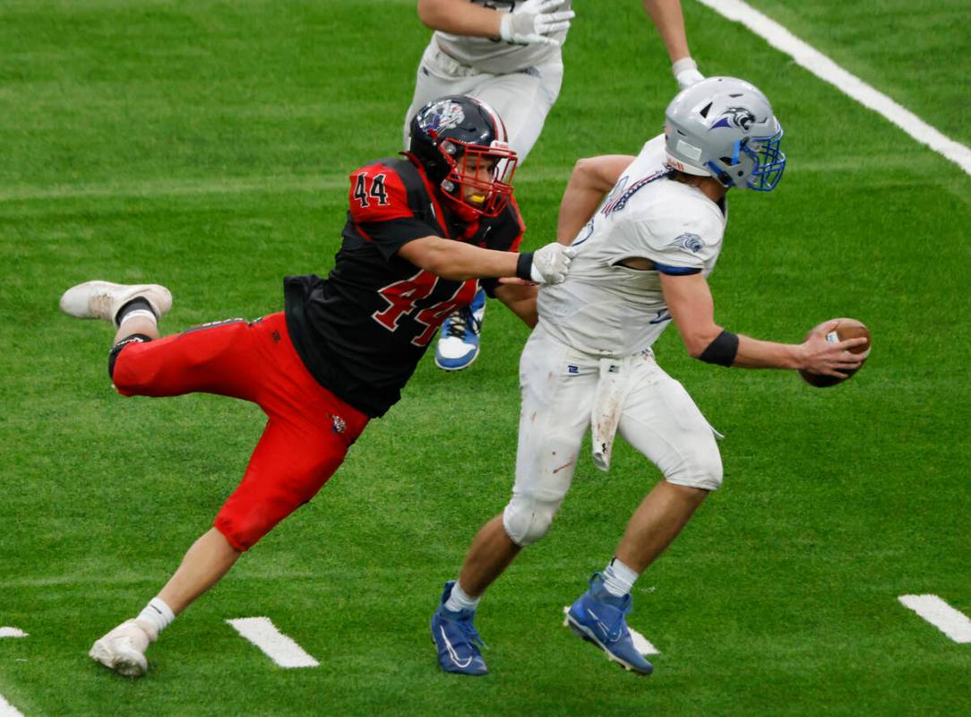 Pahranagat Valley quarterback Jesse Stewart (5) is taken down by Tonopah tight end Rhyston Wall ...