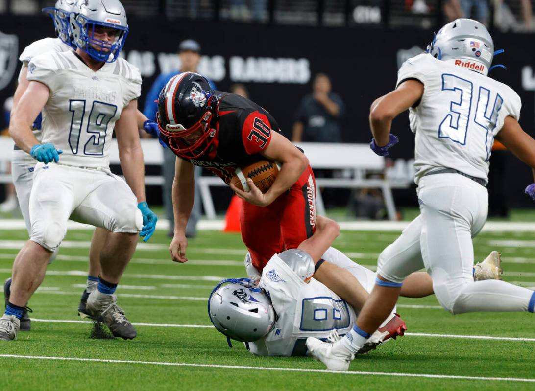 Tonopha running back Dustin Otteson (30) is taken down by Pahranagat Valley defensive back Jaco ...