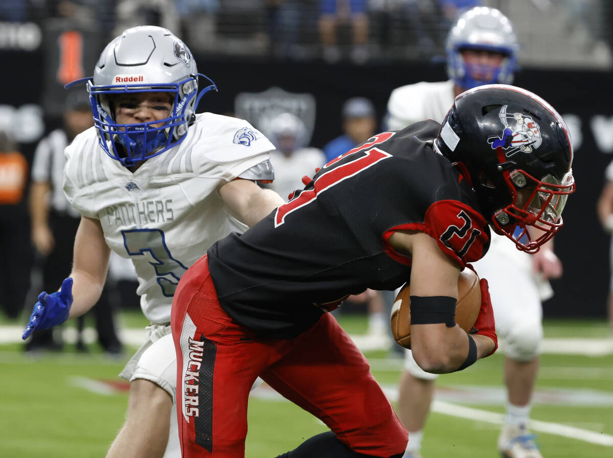 Tonopah running back Mitchell Miller (21) avoids a tackle from Pahranagat Valley defensive end ...