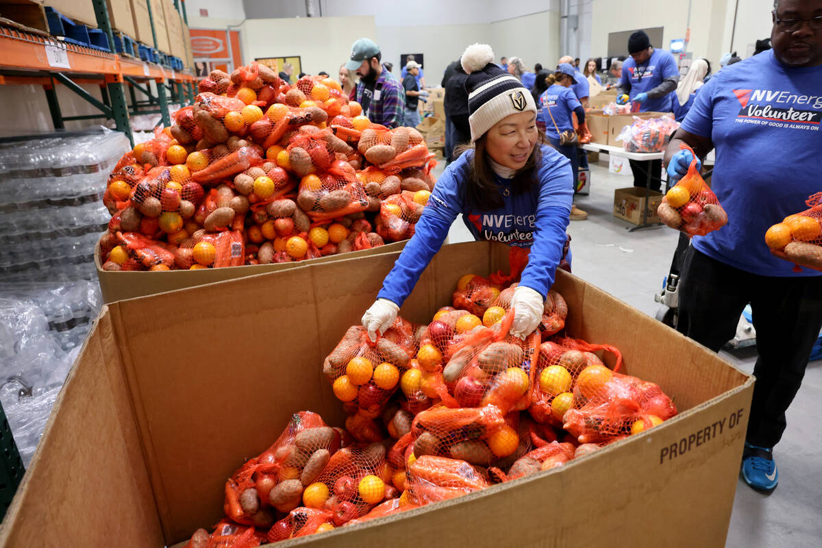 NV Energy volunteer Nobuko Bergman prepares donations on Martin Luther King Jr. Day at Three Sq ...