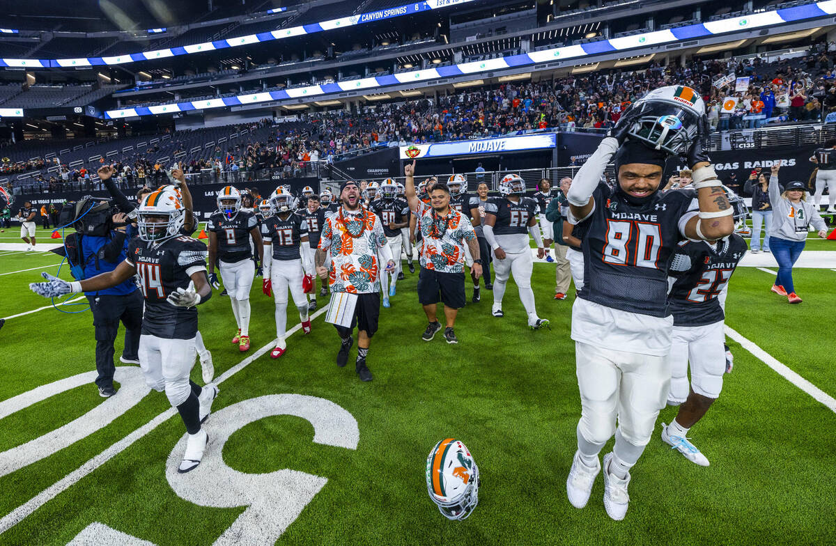 Mojave players and coaches celebrate their 30-6 win over Canyon Springs during their Class 4A f ...