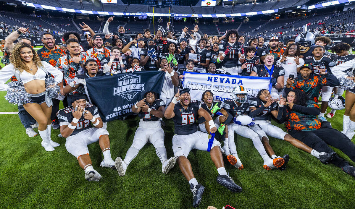 Mojave players and coaches celebrate their 30-6 win over Canyon Springs during their Class 4A f ...