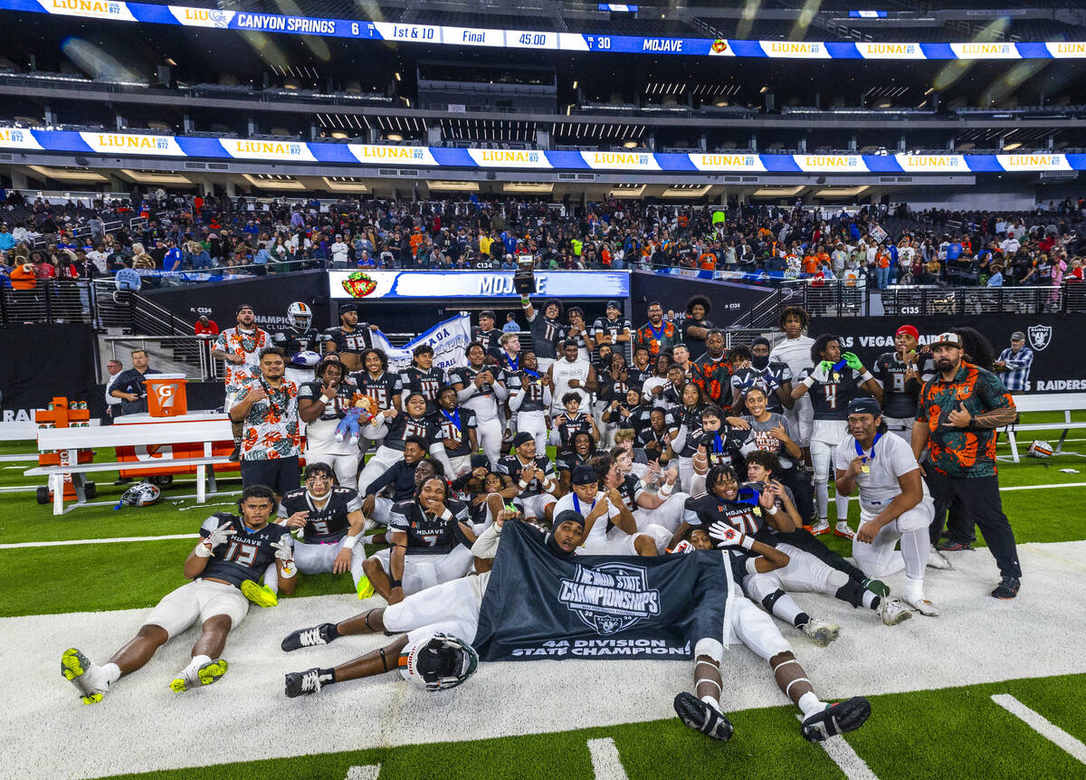 Mojave players and coaches celebrate their 30-6 win over Canyon Springs during their Class 4A f ...