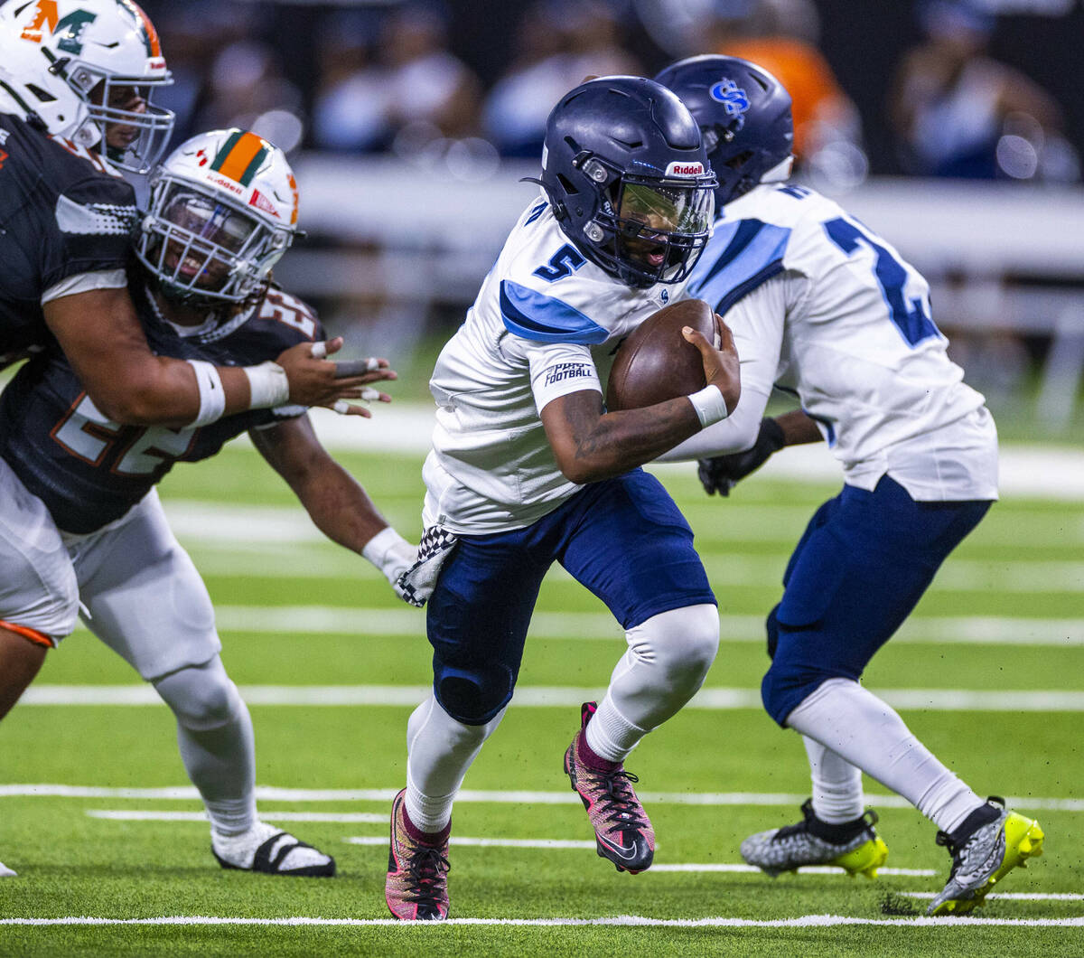 Canyon Springs quarterback Tysean McCraney (5) breaks free up the middle against Mojave during ...