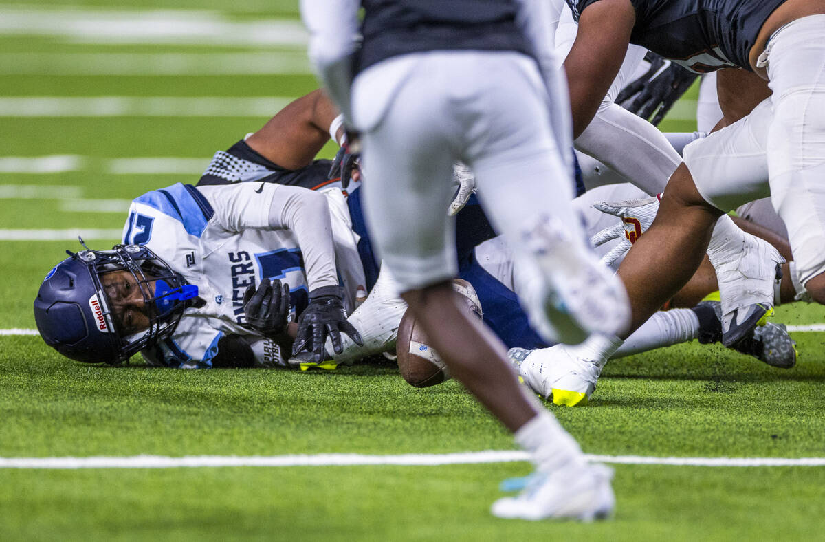 Canyon Springs running back Bakari Wilson (21) fumbles the ball against Mojave during the first ...