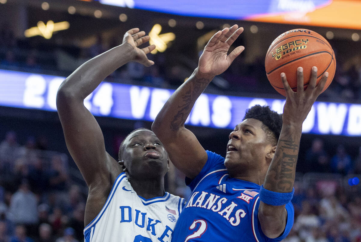 Duke Blue Devils center Khaman Maluach (9) defends Kansas Jayhawks guard AJ Storr (2) during a ...