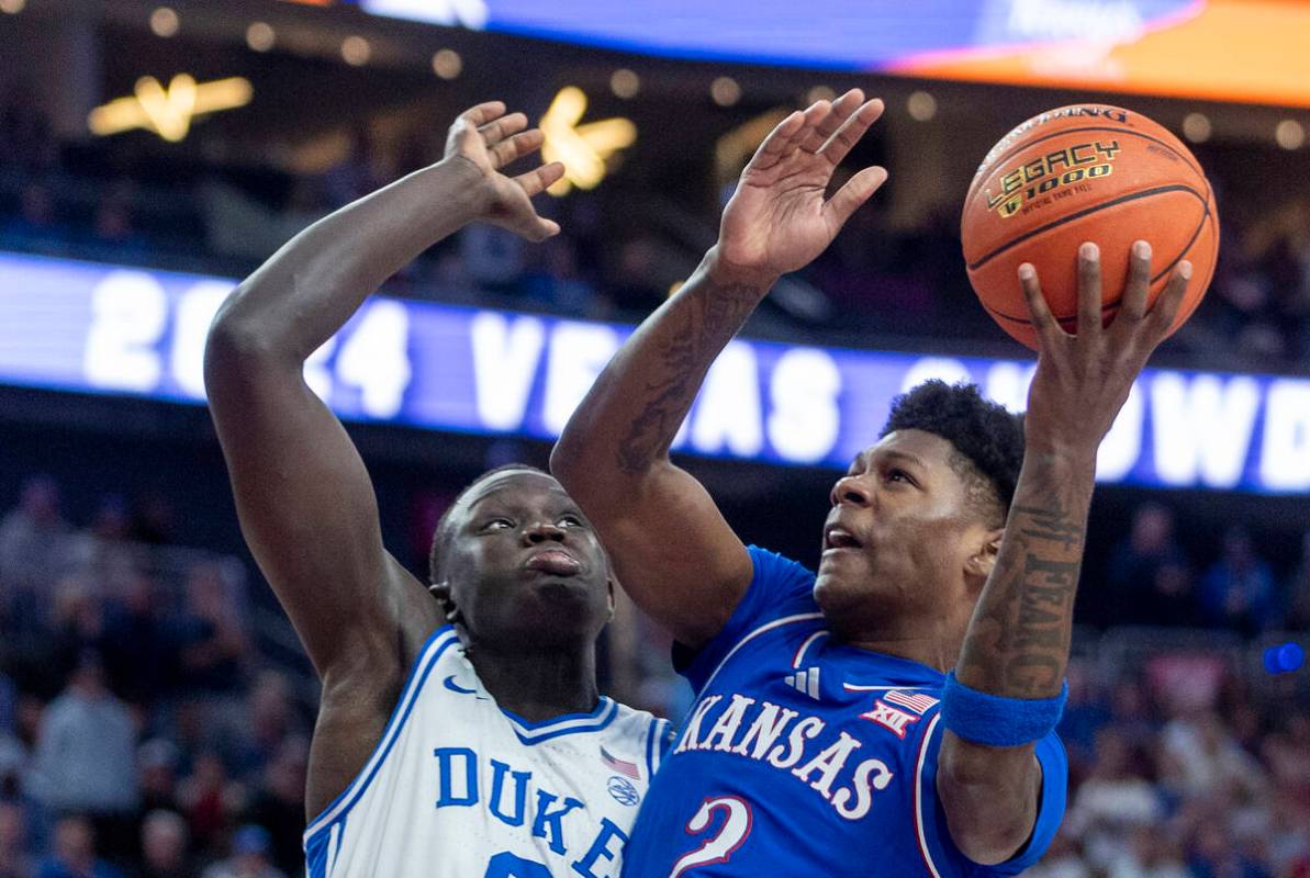 Duke Blue Devils center Khaman Maluach (9) defends Kansas Jayhawks guard AJ Storr (2) during a ...