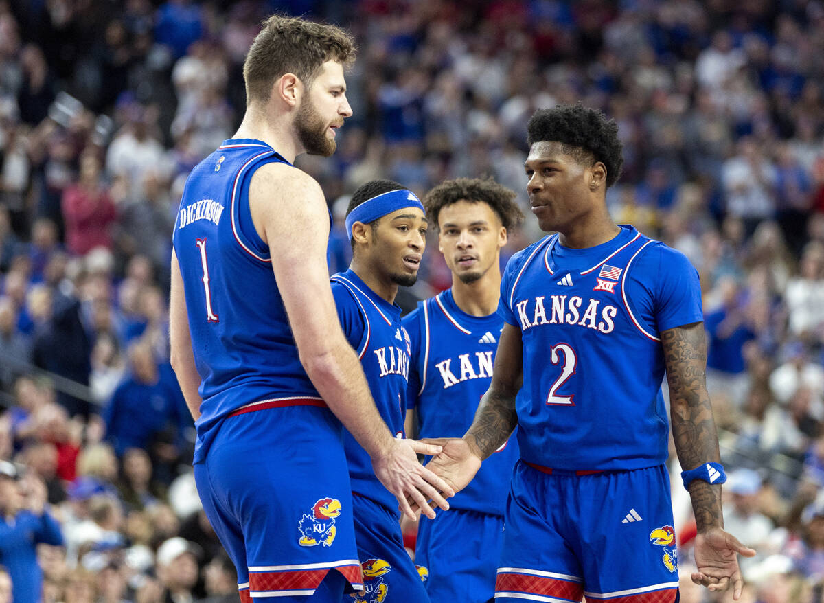 The Kansas Jayhawks meet during a break in the play during the Vegas Showdown college basketbal ...