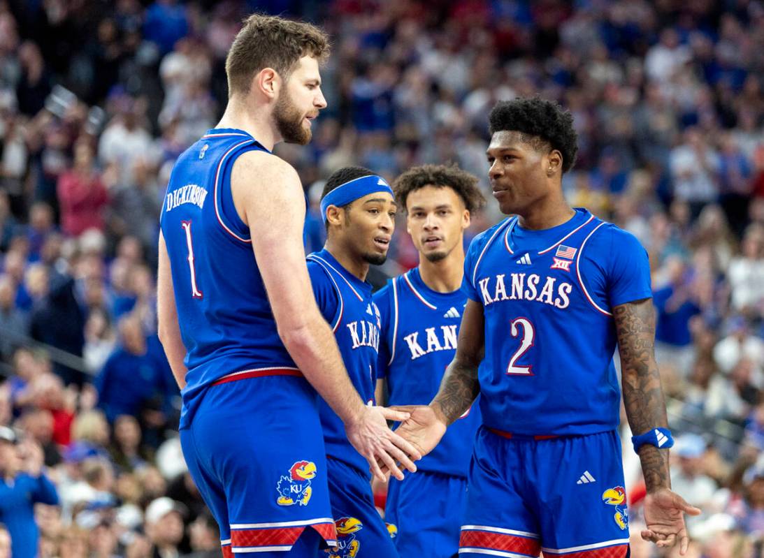 The Kansas Jayhawks meet during a break in the play during the Vegas Showdown college basketbal ...