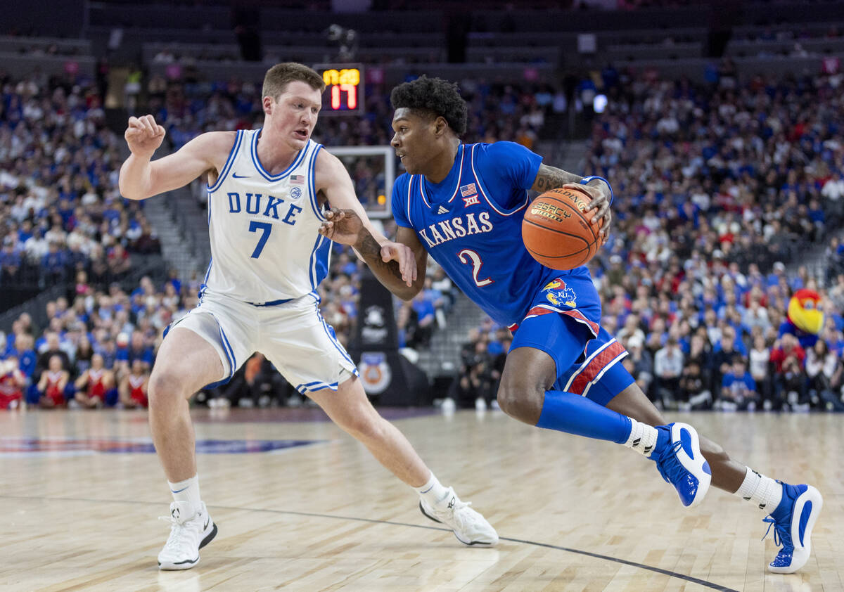 Kansas Jayhawks guard AJ Storr (2) attempts to pass Duke Blue Devils guard Kon Knueppel (7) dur ...