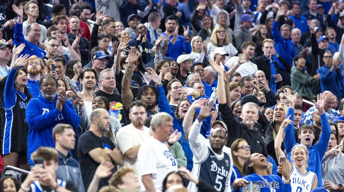 Duke Blue Devils fans wave goodbye to Kansas Jayhawks center Hunter Dickinson, not pictured, as ...