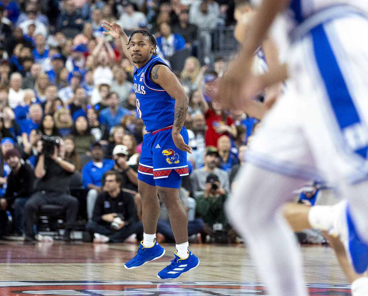 Kansas Jayhawks guard David Coit (8) holds up three fingers after making a three-point shot dur ...