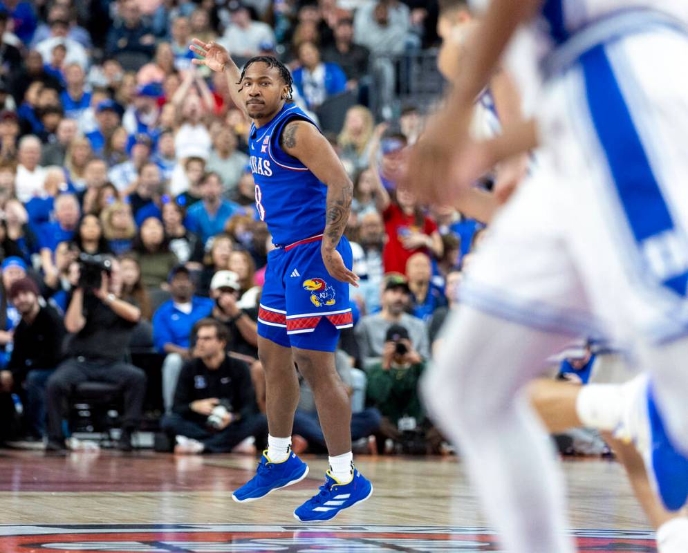 Kansas Jayhawks guard David Coit (8) holds up three fingers after making a three-point shot dur ...