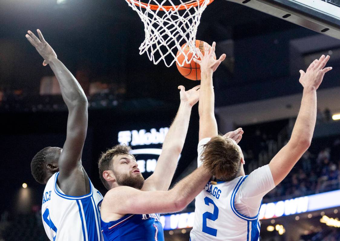 Kansas Jayhawks center Hunter Dickinson, center, attempts a layup during the Vegas Showdown col ...