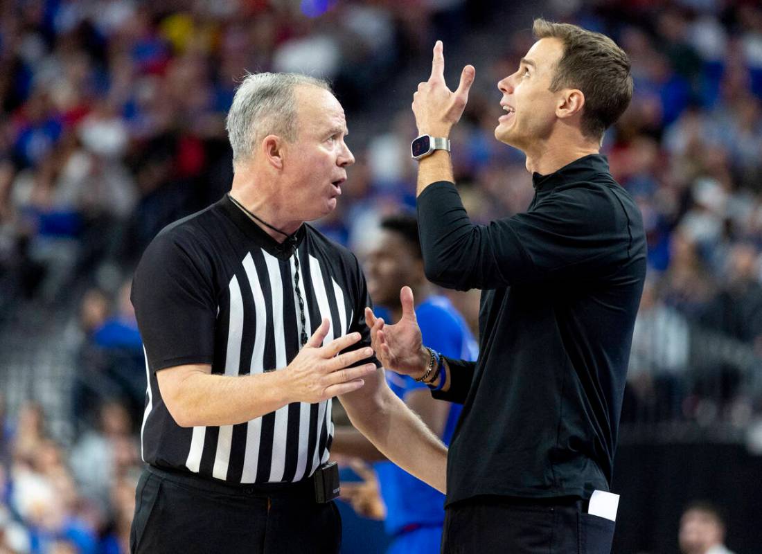 Duke Blue Devils head coach Jon Scheyer, right, points to the replay while talking to a referee ...