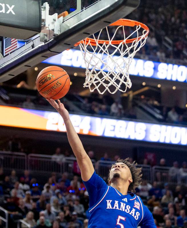 Kansas Jayhawks guard Zeke Mayo (5) attempts a layup during the Vegas Showdown college basketba ...