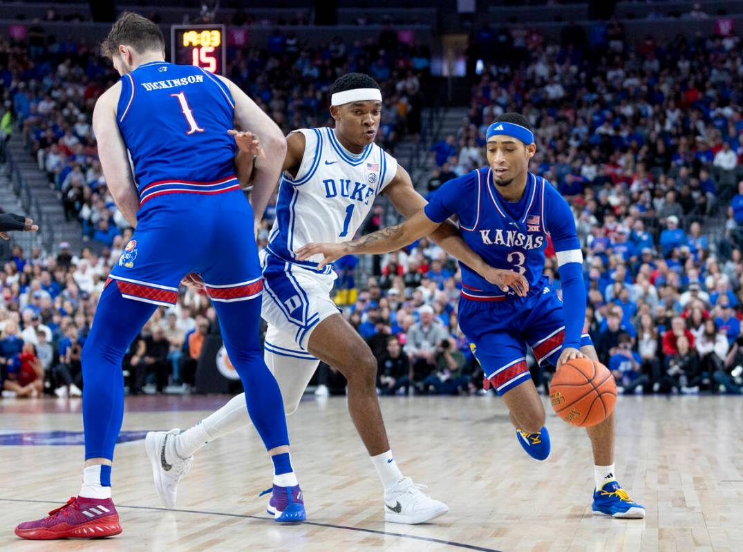 Kansas Jayhawks guard Dajuan Harris Jr. (3) attempts to pass Duke Blue Devils guard Caleb Foste ...