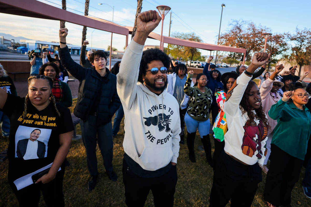 Quentin Savwoir, president of NAACP Las Vegas, raises his fist during a vigil for Brandon Durha ...