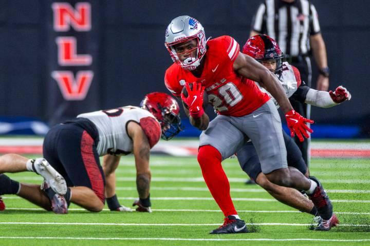 UNLV running back Kylin James (20) cuts upfield for more yards as he gets past San Diego State ...