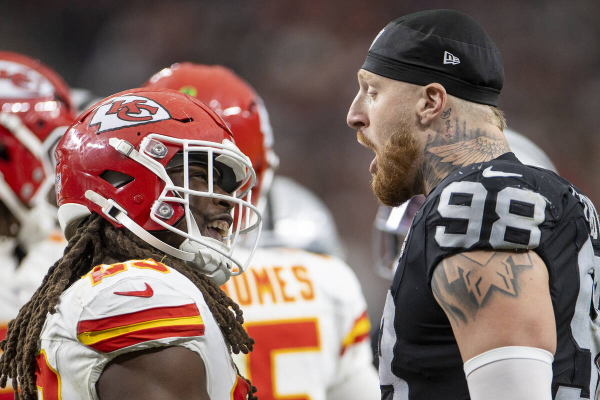 Kansas City Chiefs running back Kareem Hunt (29) and Raiders defensive end Maxx Crosby (98) exc ...