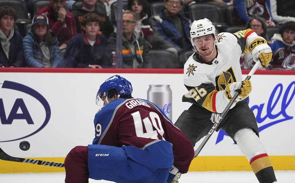 Vegas Golden Knights right wing Alexander Holtz, back, shoots the puck past Colorado Avalanche ...