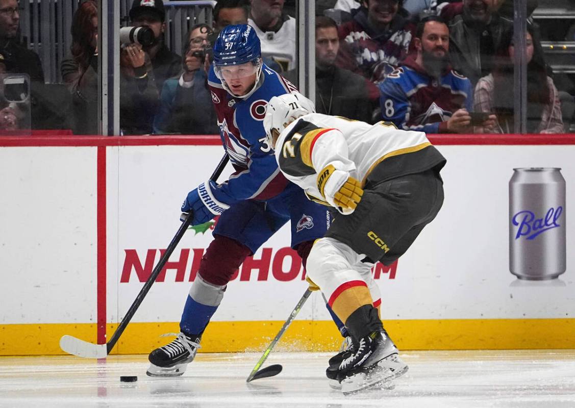 Colorado Avalanche center Casey Mittelstadt, back, looks to pass the puck as Vegas Golden Knigh ...