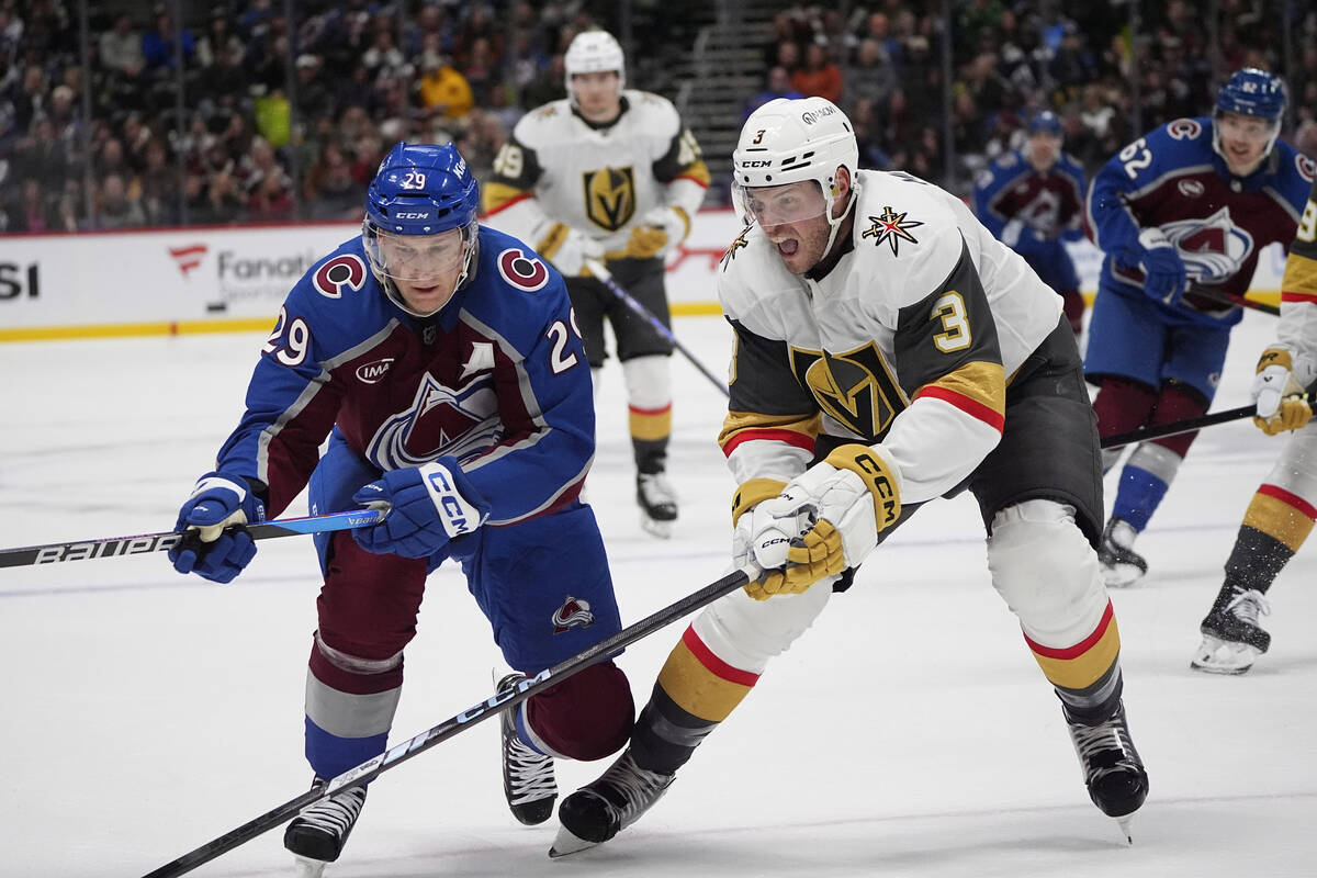 Colorado Avalanche center Nathan MacKinnon, left, pursues the puck with Vegas Golden Knights de ...