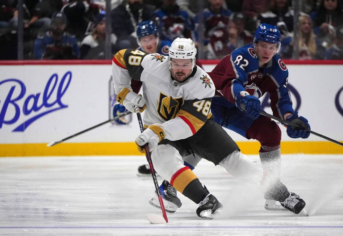 Vegas Golden Knights center Tomas Hertl, left, collects the puck as Colorado Avalanche center I ...