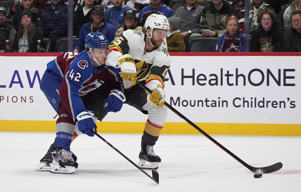 Vegas Golden Knights defenseman Noah Hanifin, right, drives past Colorado Avalanche defenseman ...