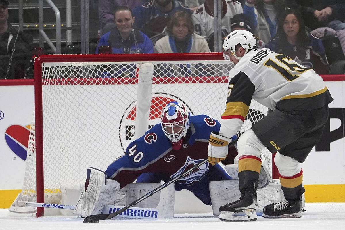 Colorado Avalanche goaltender Alexandar Georgiev, left, stops a shot by Vegas Golden Knights le ...