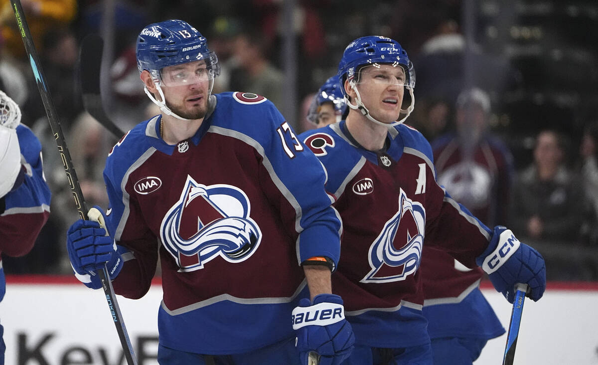 Colorado Avalanche right wing Valeri Nichushkin, left, is congratulated by center Nathan MacKin ...