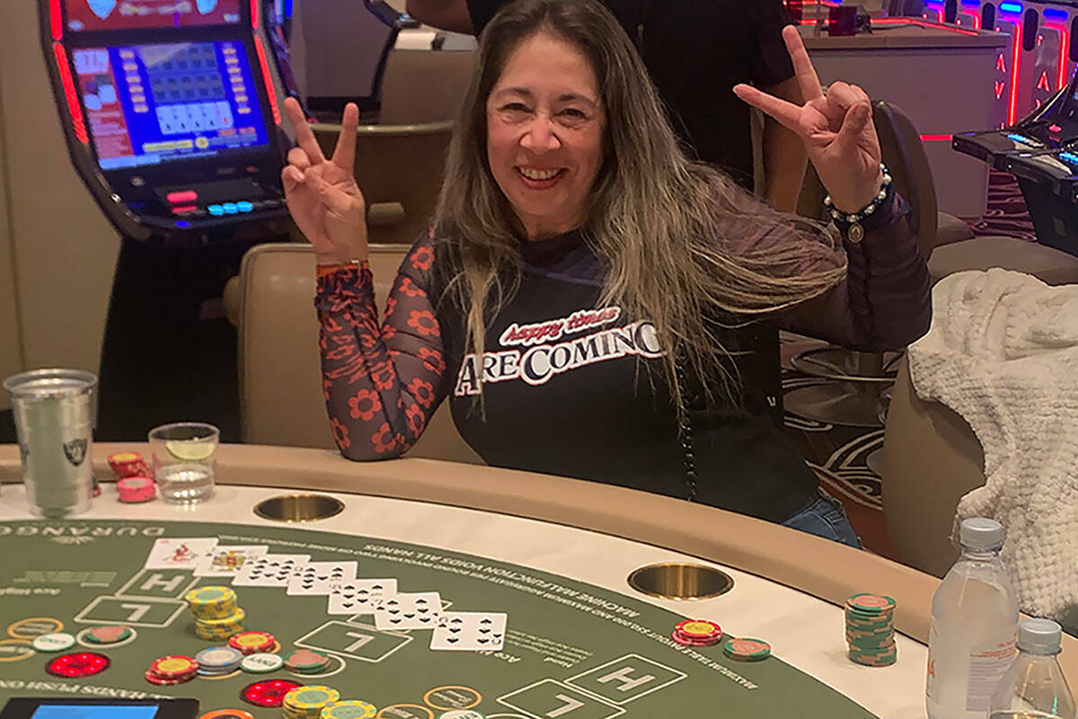 Local resident Rubi Valbuena celebrates her Pai Gow progressive jackpot win of more than $332,0 ...