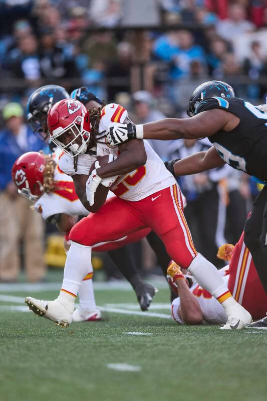 Kansas City Chiefs running back Kareem Hunt (29) runs through the tackle attempt of Carolina Pa ...