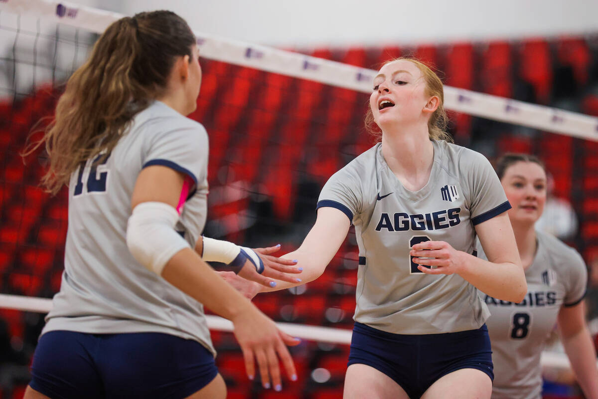 Utah State teammates Tierney Barlow (2) and Kaylie Ray (12) high five during a first round game ...