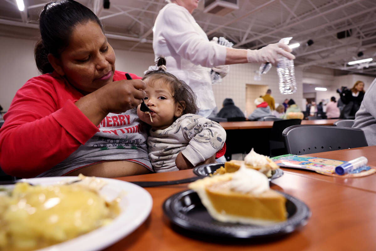 Martha Justo Alvarado and her son Lian eat during the Catholic Charities of Southern Nevada 59t ...