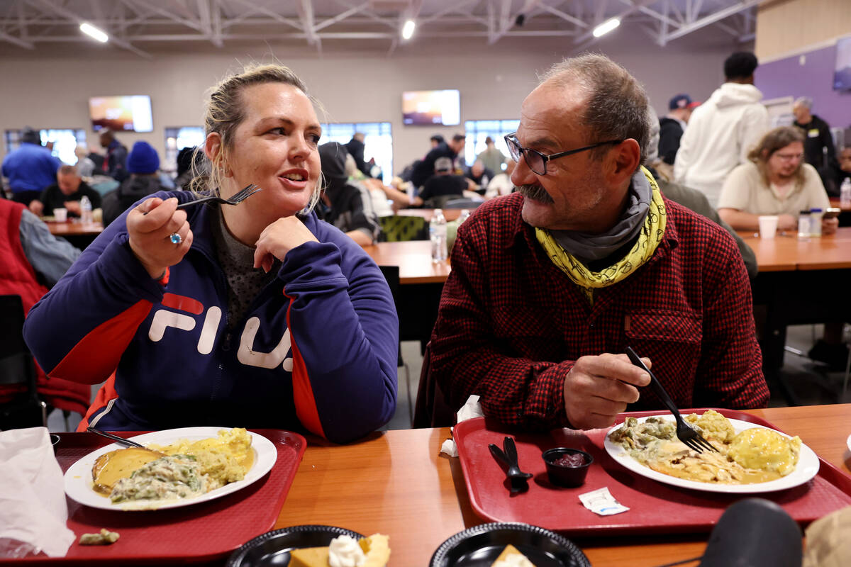 Nicole Carlson, 43, Richard Poggi, 60, eat during the Catholic Charities of Southern Nevada 59t ...