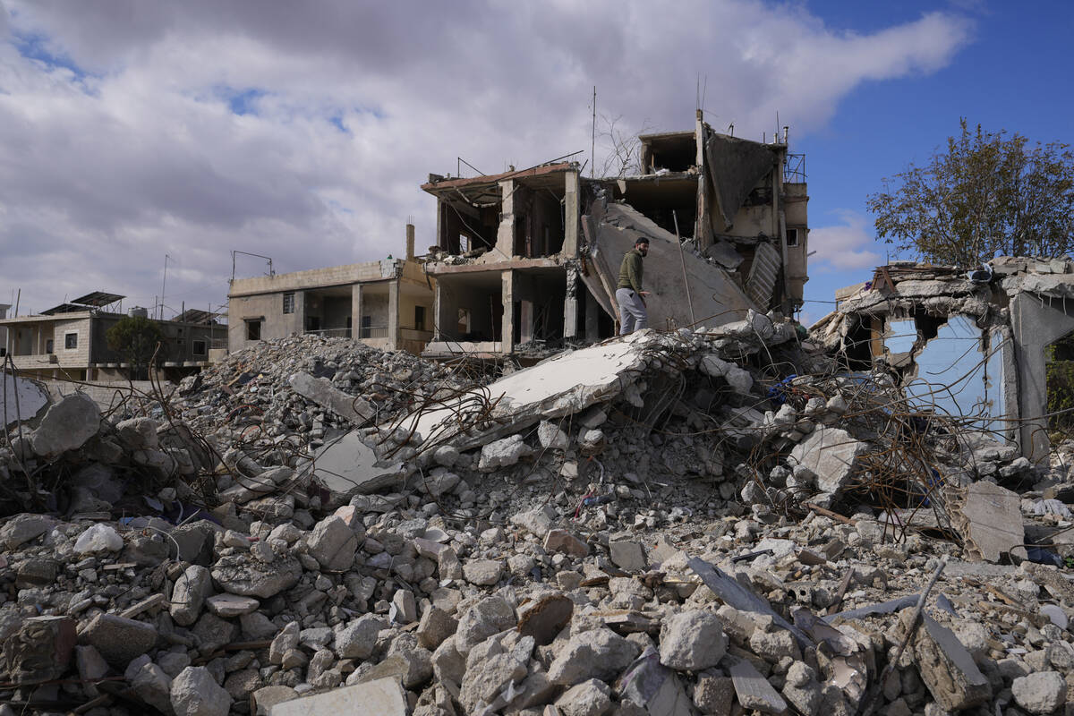 A man inspects a building destroyed in Israeli airstrikes in Baalbek, eastern Lebanon, Thursday ...