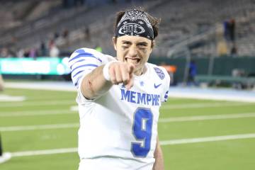 Memphis quarterback Seth Henigan (9) celebrates his team's 34-24 victory over Tulane in the sec ...